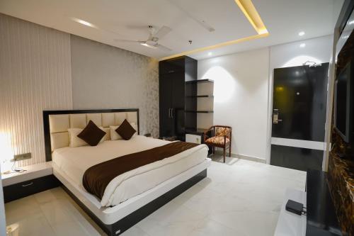 a bedroom with a bed and a desk and a chair at Royal Bliss in Patna