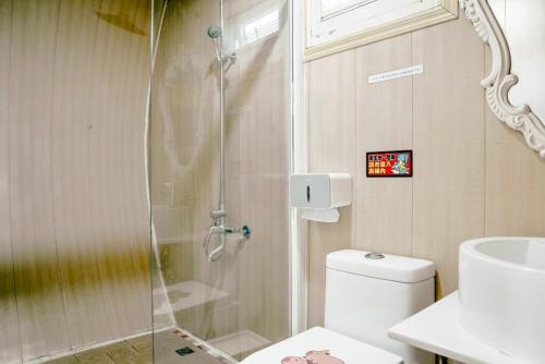 a bathroom with a shower with a toilet and a sink at 海角42號三館包棟民宿-寵物友善 in Hengchun