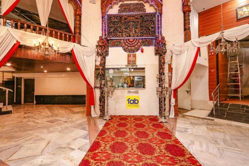 a large room with a red rug on the floor at FabHotel Maruthi Residency in Hyderabad
