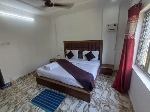 a bedroom with a bed with white sheets and pillows at The relax in hotel in Katra