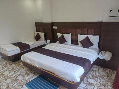 two beds in a hotel room with at The relax in hotel in Katra