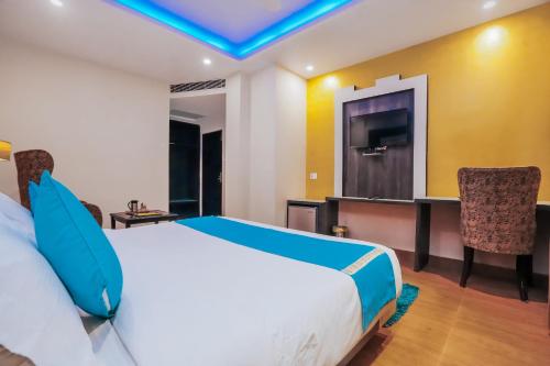 a hotel room with a bed and a television at Nature Valley View Resort Mashobra !! Luxury Choice !! gaming zone !! open terrace !! Big Parking in Shimla