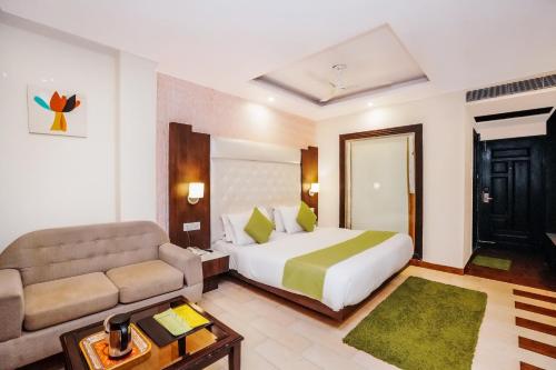 a hotel room with a bed and a couch at Nature Valley View Resort Mashobra !! Luxury Choice !! gaming zone !! open terrace !! Big Parking in Shimla