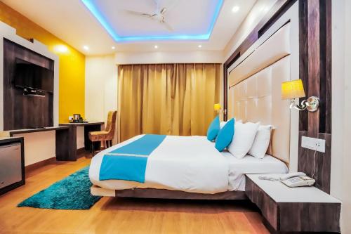 a hotel room with a bed and a tv at Nature Valley View Resort Mashobra !! Luxury Choice !! gaming zone !! open terrace !! Big Parking in Shimla