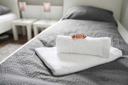a white towel with a ring on it on a bed at Apartment in Schwerte in Schwerte
