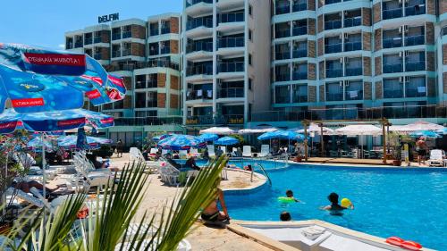 a swimming pool with people in a resort at Hotel Delfin - All Inclusive in Sunny Beach
