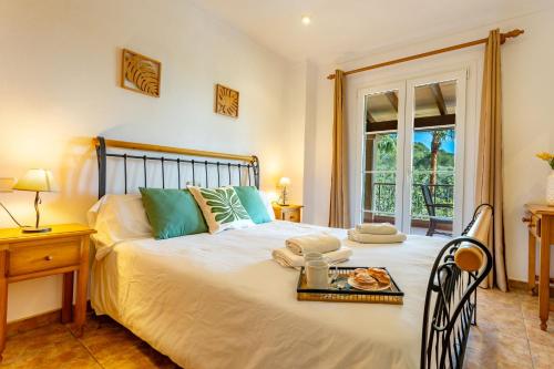 a bedroom with a bed with a tray of food on it at Finca Es Recer - ETV/1.751 in Santanyi