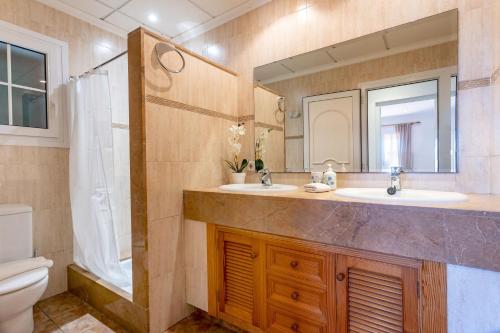 a bathroom with two sinks and a large mirror at Finca Es Recer - ETV/1.751 in Santanyi