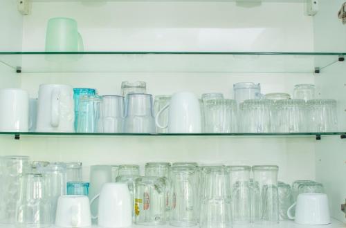 a bunch of glass jars sitting on shelves at PX POOL VILLA PATTAYA in Nong Prue