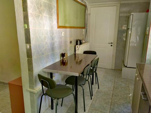 a kitchen with a table and chairs and a refrigerator at ILIAKTI RELAXING SEASIDE in Salamís