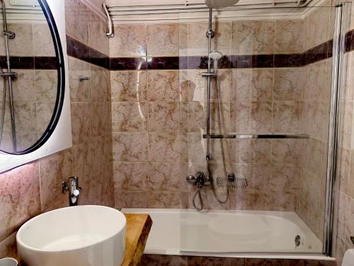 La salle de bains est pourvue d'une douche, d'une baignoire et d'un lavabo. dans l'établissement ILIAKTI RELAXING SEASIDE, à Salamine