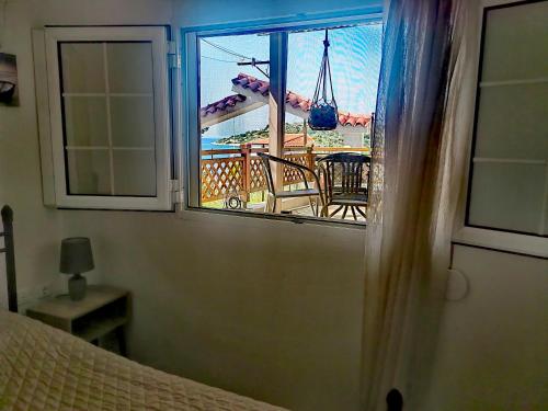 a bedroom with a window looking out at the carnival ride at ILIAKTI RELAXING SEASIDE in Salamís