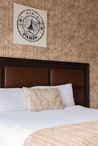 a bedroom with a bed and a poster on the wall at Evans Village - Apartments & Spa in Johannesburg