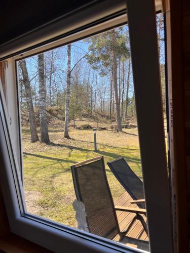 two chairs sitting on a porch looking out of a window at Katase Tiny House in Katase