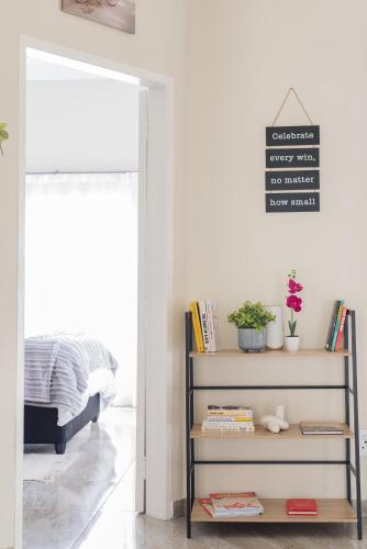 a room with a book shelf and a sign on the wall at Evans Village - Apartments & Spa in Johannesburg