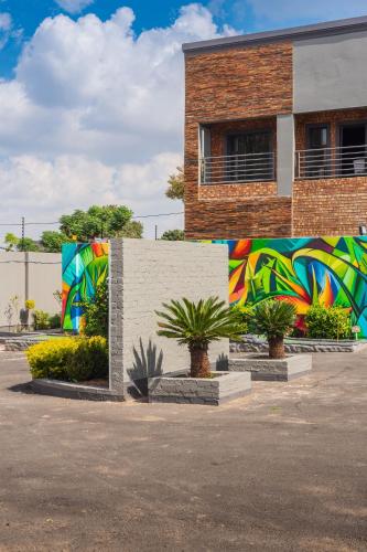a building with a colorful mural on the side of it at Evans Village - Apartments & Spa in Johannesburg