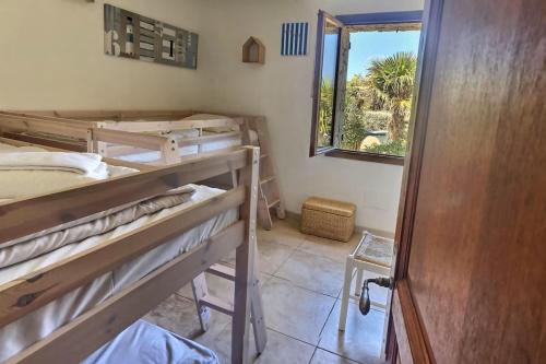 une chambre avec trois lits superposés et une fenêtre dans l'établissement Casa U Maelou, à Lumio