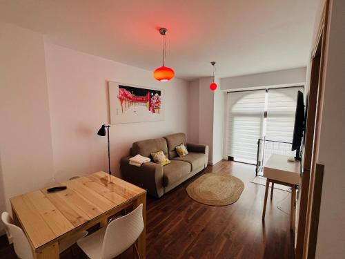a living room with a couch and a table at Apartamento RENACIMIENTO con garaje in Badajoz
