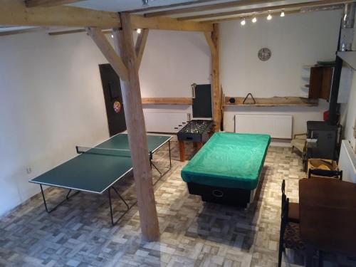 a room with two ping pong tables in a room at Penzion Hrnčíře in Benešov