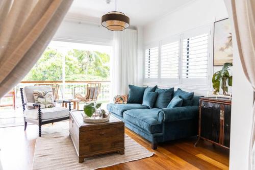 a living room with a blue couch and a table at Coco's - in town {Ultima Collection} in Port Douglas