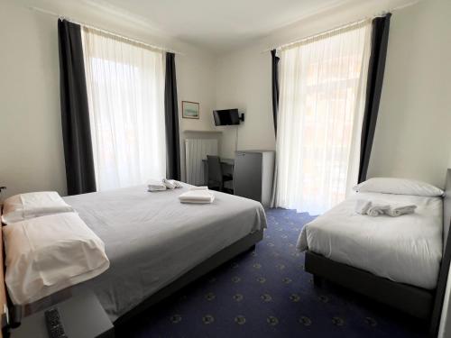 Ένα ή περισσότερα κρεβάτια σε δωμάτιο στο Hotel Regina del Bosco