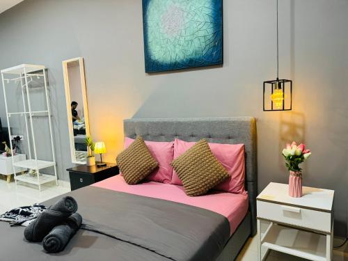a bedroom with a bed with pink pillows and a mirror at CoreSoho Suite by BKAstaycation KotaWarisan Sepang KLIA Airport, Free Wifi in Sepang