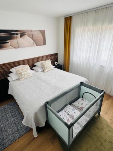 a bedroom with a bed with a white bedspread at Kuća za odmor Sedra - jacuzzi & sauna in Hrvatska Kostajnica