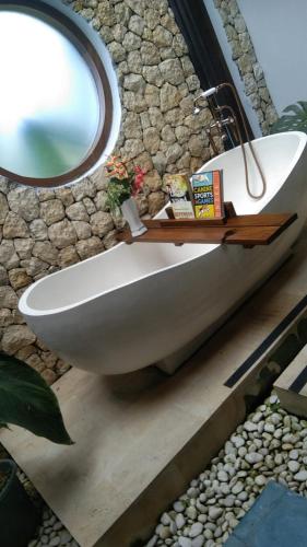 a bathroom with a white sink and a mirror at casa idea ubud in Ubud