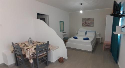 a bedroom with a bed and a table and a tub at Summer House Paliochori in Paliochori
