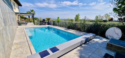 a swimming pool in the backyard of a house at Victory Garda Relais - swimming pool-jacuzzi-bbq in Soiano del Lago