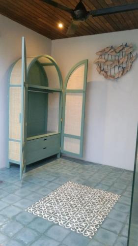 a room with two glass doors and a rug on the floor at casa idea ubud in Ubud