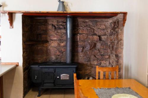 a stone wall with a stove in a room at Dunn's Castle in Piketberg
