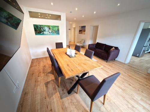 a dining room with a wooden table and chairs at Luxus mit Schwarzwaldromantik pur! in Ottenhöfen