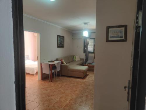 a living room with a couch and a table at Apartment Seaview Golem Devi in Golem