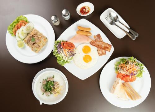 four plates of breakfast food on a table at Lily Hotel Bangkok in Bangkok