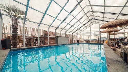 a large swimming pool with a glass ceiling at Majoong Pool Villa Pension in Gyeongju