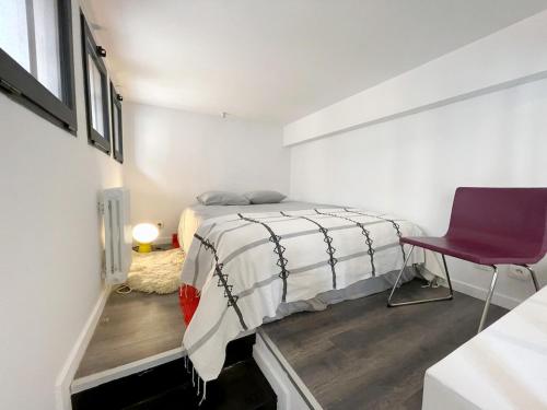 a bedroom with a bed and a purple chair at TEA&CHILL - Nice Triplex Loft - with garden in Montreuil