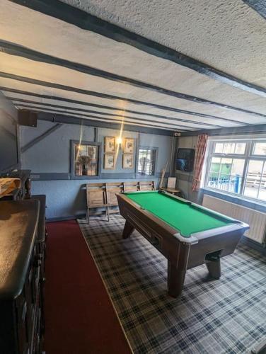 a living room with a pool table in it at Blue Bell Apartment in Kidsgrove