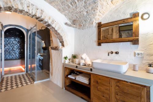 a bathroom with a sink and a shower at Trulli Tower in Putignano