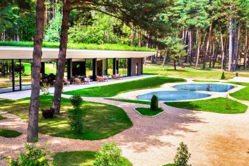 a house with a pool in the middle of a yard at Bioli Wellness Resort in Kojori