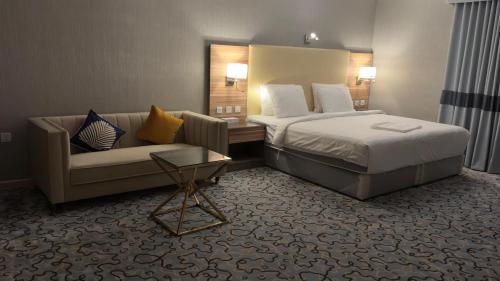 a hotel room with a bed and a couch at فندق الشهباء الفيحاء Hotel Al Shahba Al Faiha Jeddah in Jeddah