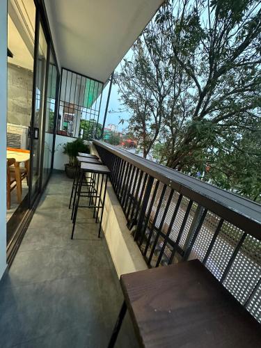 a balcony of a building with tables and chairs at Clover Home Quảng Bình in Dong Hoi