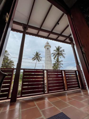 a view of a lighthouse from the porch of a house at Light House View Inn - Galle Fort in Galle