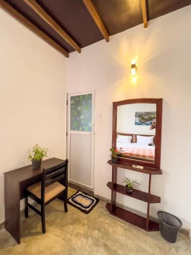 a dressing room with a mirror and a table at Light House View Inn - Galle Fort in Galle