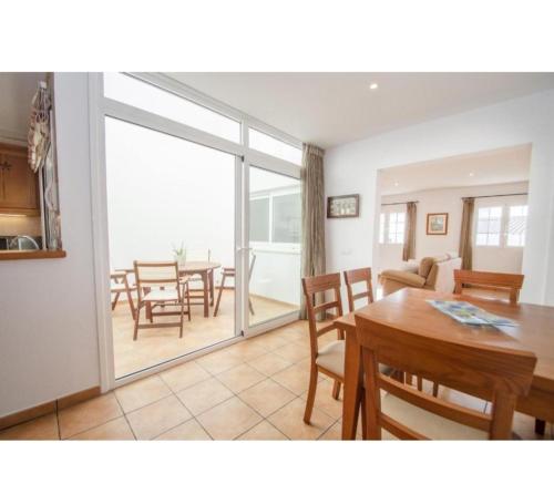 a kitchen and dining room with a table and chairs at Casa Maria in Fornells