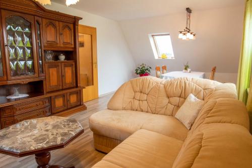 a living room with a couch and a table at Ferienwohnung Sukow in Freest