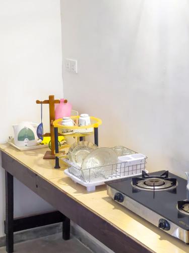 a table with a counter top with dishes on it at Light House View Inn - Galle Fort in Galle