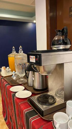 a kitchen counter with a mixer on a table at Aquavista Hotel & Suites in Aqaba