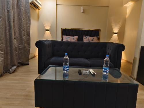 two water bottles sitting on a coffee table in a living room at 4 Season hotel in Lucknow