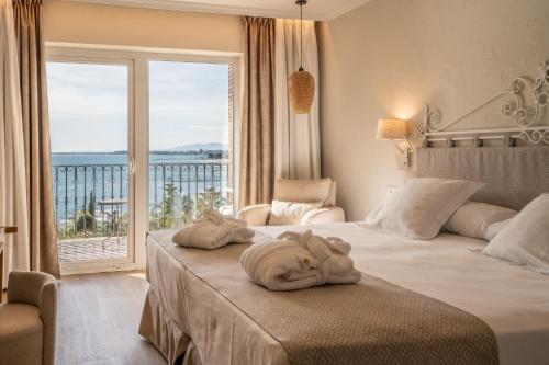 a hotel room with two beds and a large window at PALASIET Thalasso Clinic&Hotel in Benicàssim